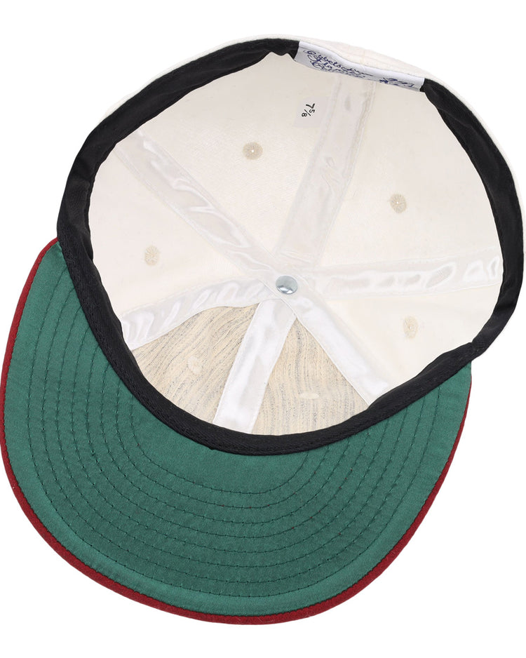 The image shows the inside of the EFF University of Alabama 1950 Vintage Ballcap, featuring a green brim with red edge, white interior panels, black lining, visible size label, and detailed top button stitching.