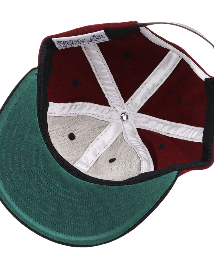 A look inside the EFF University of South Carolina Gamecocks Vintage Ballcap reveals a green underbrim, burgundy crown, white seams, black eyelets, and an adjustable strap—an officially licensed College Vault item.