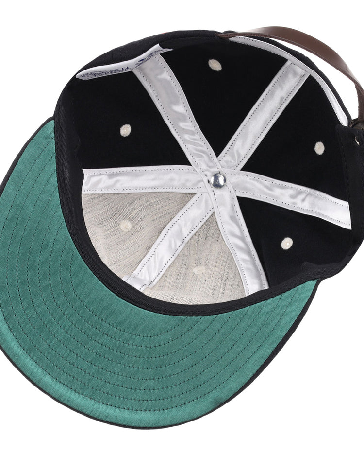 The image shows the inside view of the EFF University of South Carolina Gamecocks Mascot Vintage Ballcap, featuring a black design with a green brim underside, white stitching, metal eyelets, and an adjustable leather back strap.