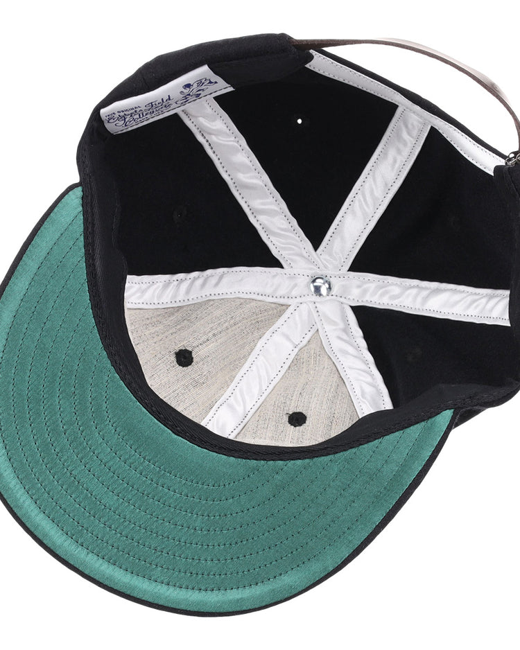 The image shows the inside of an EFF Grambling State University 1963 Vintage Ballcap with a black wool exterior, green underbrim, white stitched “X” panels, and an adjustable strap—a perfect HBCU collectible.