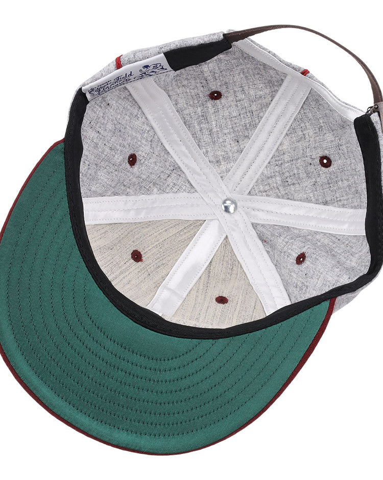 A look inside the EFF Loyola Marymount University 1939 Vintage Ballcap shows its green underbrim, red stitching, adjustable brown strap, visible internal seams, and ventilation holes—classic features of this historic hat.