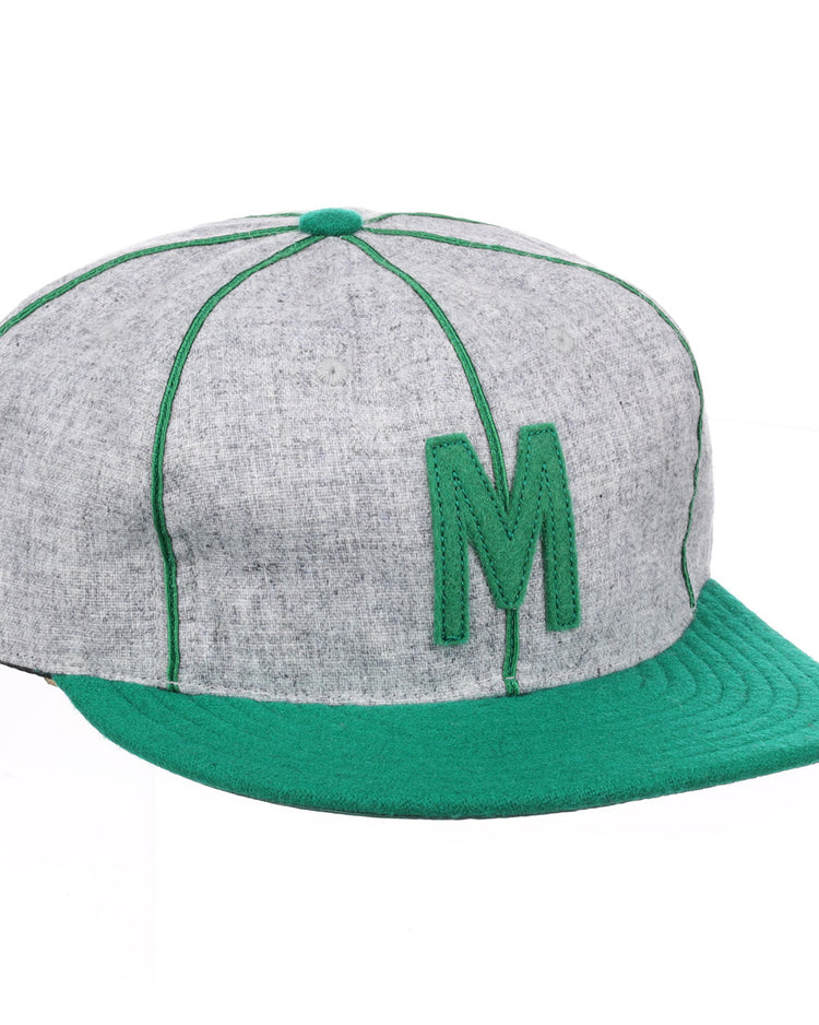 The EFF Manhattan College 1932 Vintage Ballcap features genuine wool in gray and green, with a green letter M, matching stitching, brim, and top button.