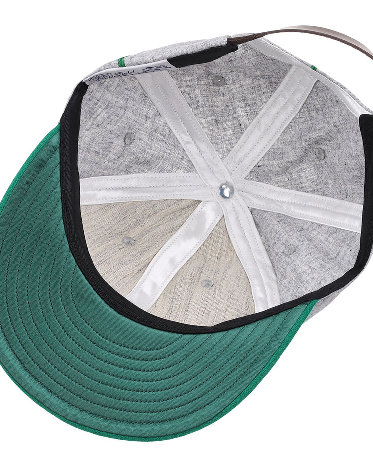 The image shows the inside of the EFF Manhattan College 1932 Vintage Ballcap, featuring a green brim, gray genuine wool panels, white stitched seams, and an adjustable brown back strap.