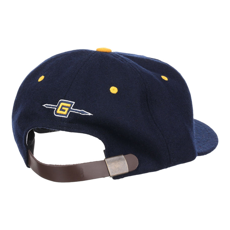 The EFF University of North Carolina Greensboro Mascot Vintage Ballcap in navy features a leather strap with metal buckle, yellow stitching, and an embroidered G with arrow—classic details inspired by vintage wool caps.