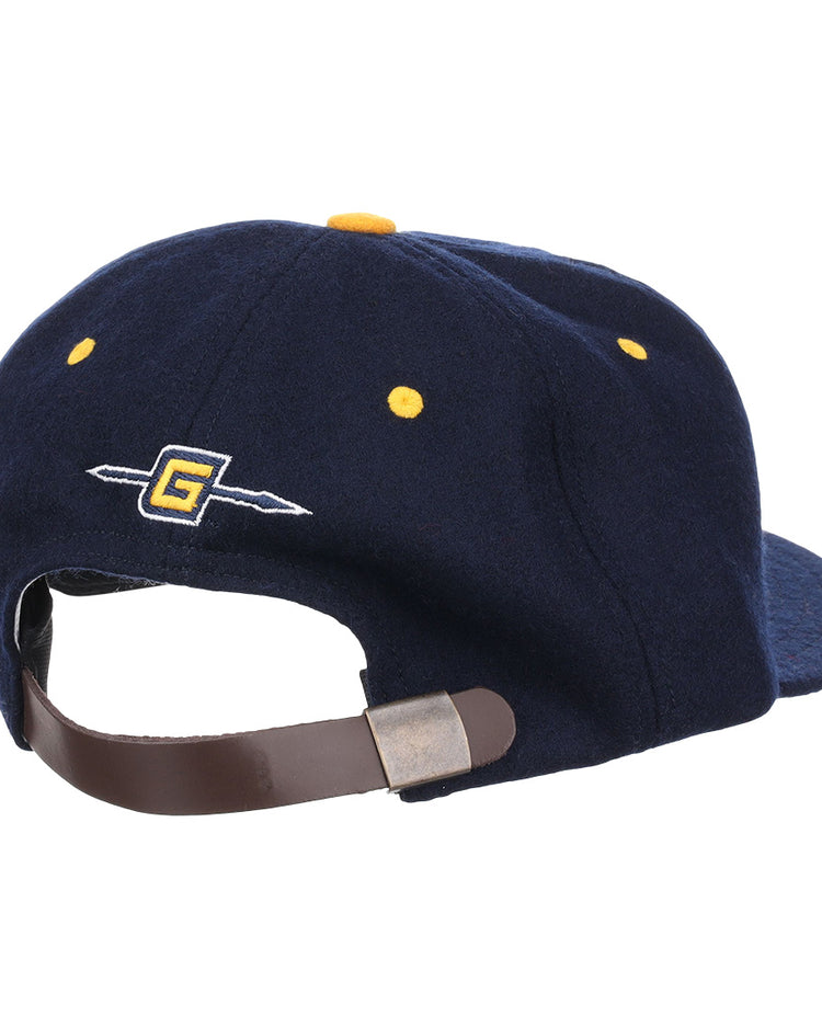 The EFF University of North Carolina Greensboro Mascot Vintage Ballcap in navy features a leather strap with metal buckle, yellow stitching, and an embroidered G with arrow—classic details inspired by vintage wool caps.