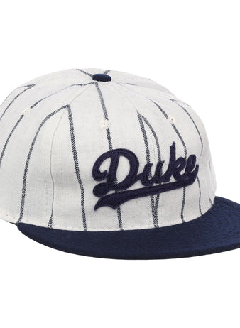 The EFF Duke University Pinstripe Script Vintage Ballcap features thin navy pinstripes on white, a navy brim, and Duke embroidered in navy script for a classic baseball look.