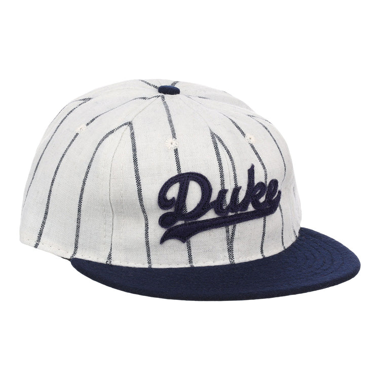 The EFF Duke University Pinstripe Script Vintage Ballcap features thin navy pinstripes on white, a navy brim, and Duke embroidered in navy script for a classic baseball look.