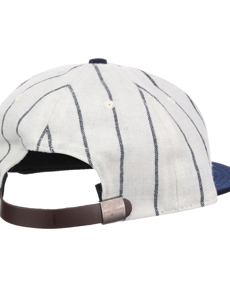 The EFF Duke University Pinstripe Script Vintage Ballcap, shown from the back, features white fabric with thin navy stripes, a brown adjustable strap with metal buckle, a blue brim partially visible in front—an authentic 1968 reproduction.