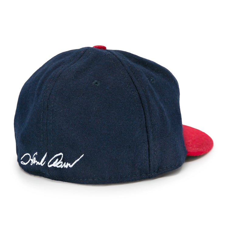 The Ebbets Field Flannels Hank Aaron 1957 Signature Series Ballcap is a vintage-style navy wool cap with a red brim and Hank Aaron’s signature embroidered in white on the back, made in the USA.