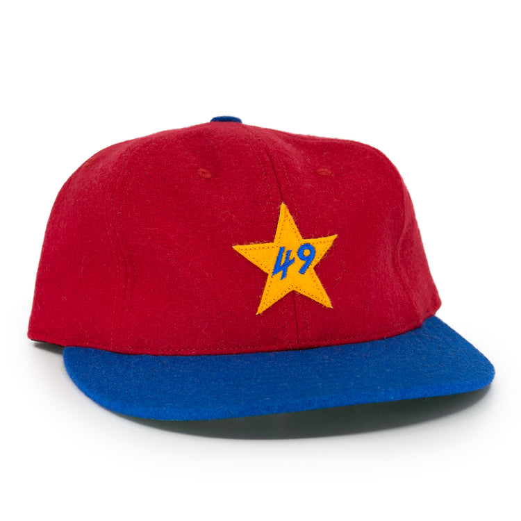 The EFF Alaska Goldpanners 1964 Vintage Ballcap is a red cap with a blue brim, yellow star, and blue “49” embroidered on the front—an authentic reproduction of the classic original.