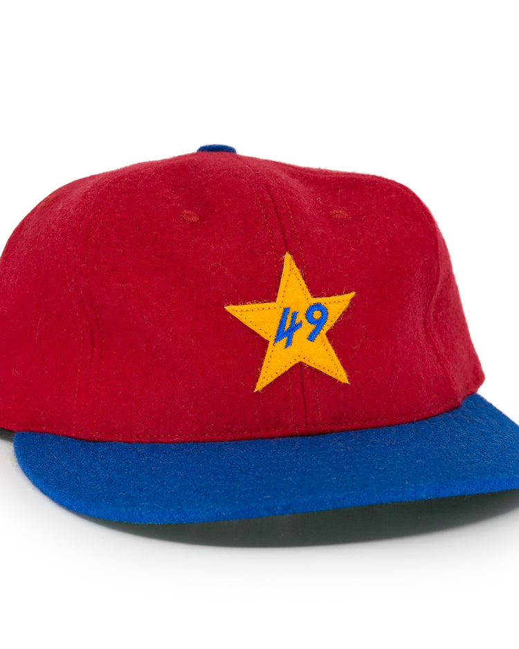 The EFF Alaska Goldpanners 1964 Vintage Ballcap is a red cap with a blue brim, yellow star, and blue “49” embroidered on the front—an authentic reproduction of the classic original.