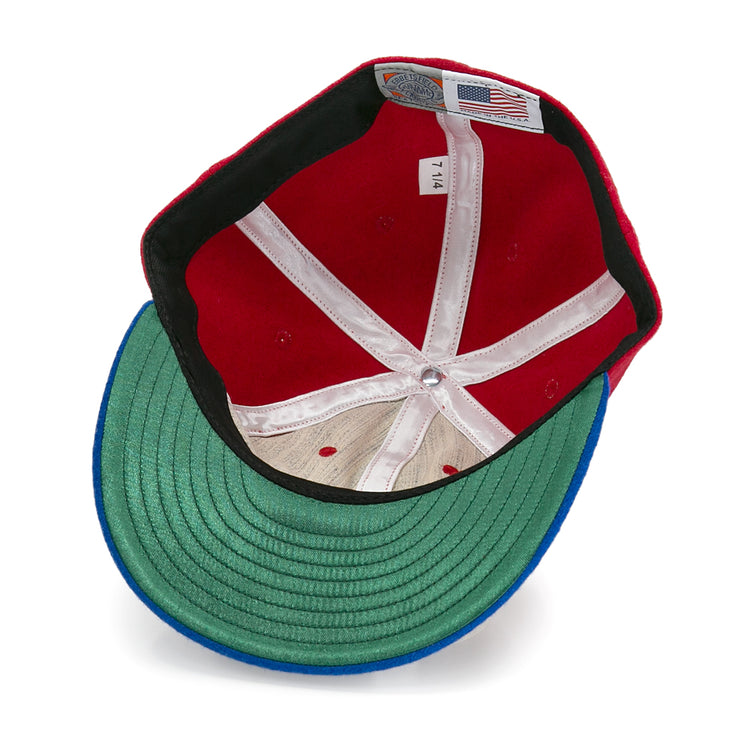 The inside of the Alaska Goldpanners 1964 Vintage Ballcap by EFF features a green underbill, white seams, mesh crown, size tag marked 7 1/4, and an American flag label—an authentic reproduction of the classic ballcap.