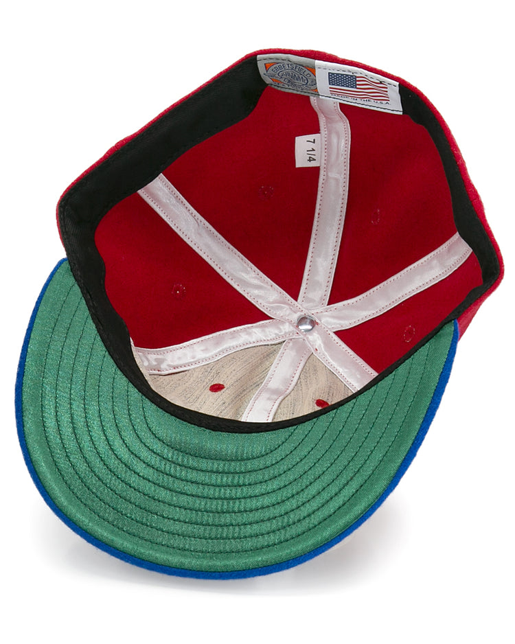 The inside of the Alaska Goldpanners 1964 Vintage Ballcap by EFF features a green underbill, white seams, mesh crown, size tag marked 7 1/4, and an American flag label—an authentic reproduction of the classic ballcap.