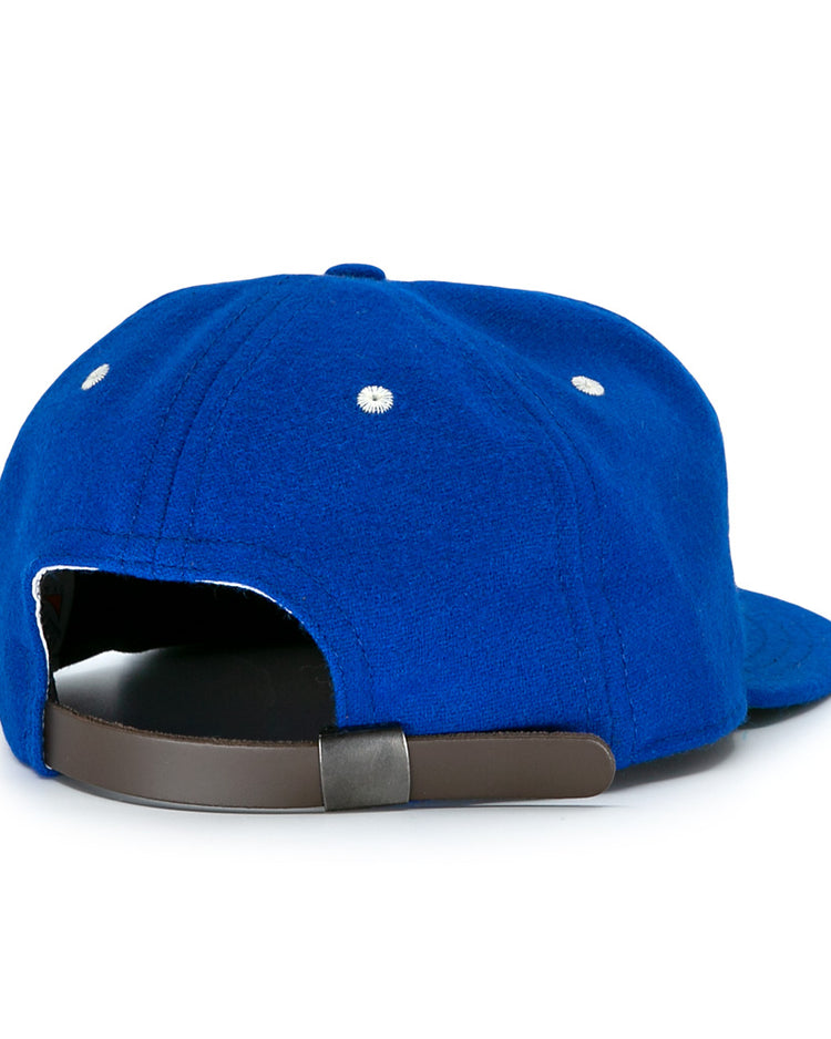 The Almendares Alacranes 1947 Vintage Ballcap by Ebbets Field Flannels is a blue wool hat shown from the back, featuring a dark adjustable strap and two white ventilation eyelets on each side.