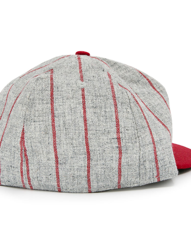 The Club Artemisa 1943 Vintage Ballcap by Ebbets Field Flannels features gray wool with vertical red stripes, a solid red brim, and a classic back view inspired by the Cuban National Amateur League.