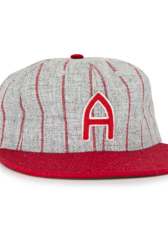 The Club Artemisa 1943 Vintage Ballcap by Ebbets Field Flannels features genuine grey wool, thin red stripes, a red brim, and a bold red A on the front, inspired by the Cuban National Amateur League team.