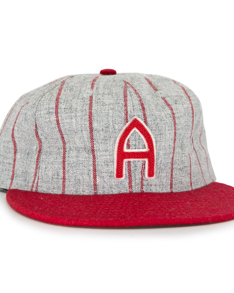 The Club Artemisa 1943 Vintage Ballcap by Ebbets Field Flannels features genuine grey wool, thin red stripes, a red brim, and a bold red A on the front, inspired by the Cuban National Amateur League team.