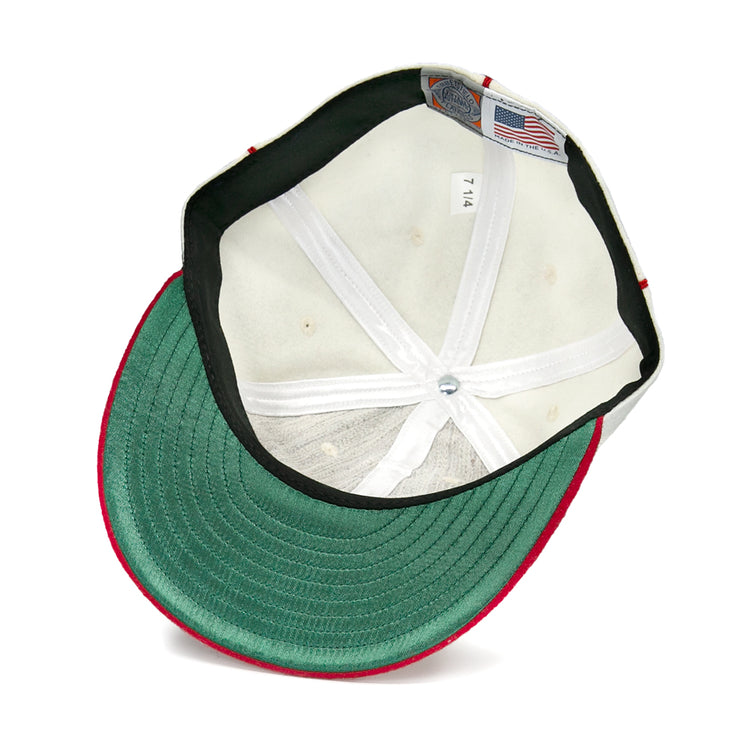The underside of this Asahi Vancouver 1940 Vintage Ballcap by EFF features a green brim, white stitched lining, a 7 1/4 size tag, an American flag label, and red edging—a tribute to the Japanese-Canadian team.