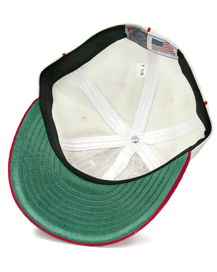 The underside of this Asahi Vancouver 1940 Vintage Ballcap by EFF features a green brim, white stitched lining, a 7 1/4 size tag, an American flag label, and red edging—a tribute to the Japanese-Canadian team.