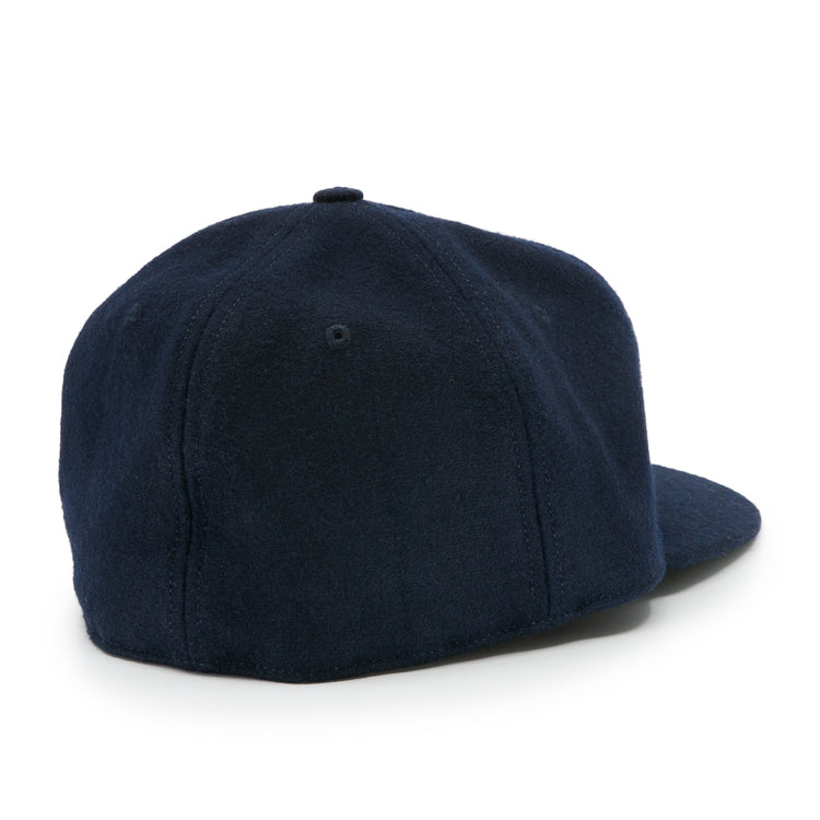 The Auburn University 1966 Vintage Ballcap by Ebbets Field Flannels is a navy blue wool baseball cap with a round crown and curved brim, viewed from the back. It features soft fabric, no adjustable strap, and a classic logo-free design.