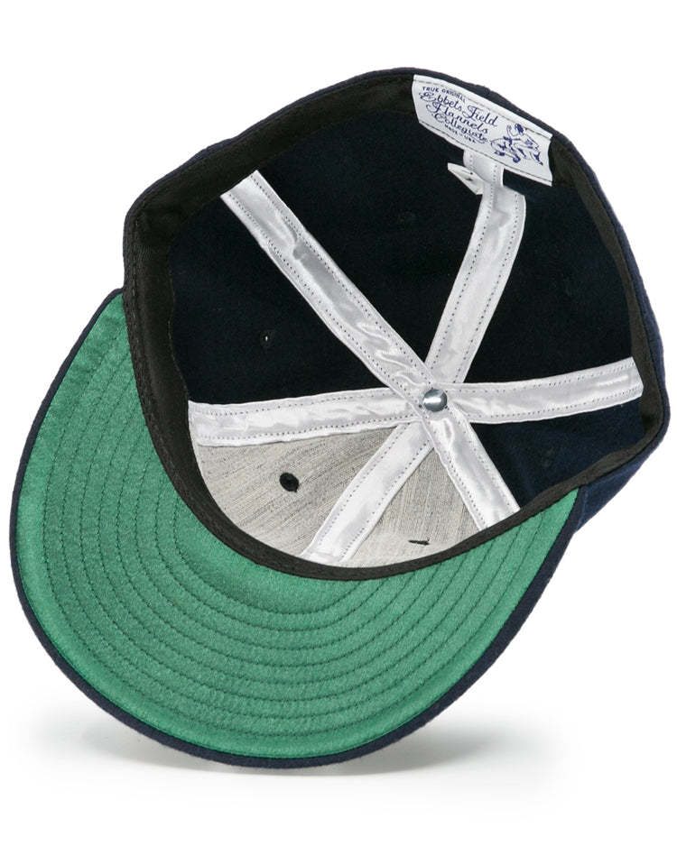 The underside of the Auburn University 1966 Vintage Ballcap by Ebbets Field Flannels features a green bill, white stitched panels, silver top button, and an interior Auburn University ballcap tag.