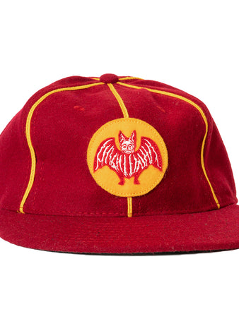 The Ebbets Field Flannels Club Bacardi 1930 Vintage Ballcap is a genuine wool cap in red with yellow piping and a circular front patch featuring an embroidered red bat—a tribute to the Cuban National Amateur League.