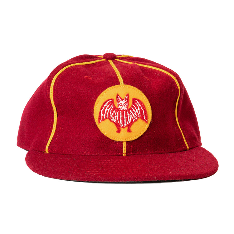 The Ebbets Field Flannels Club Bacardi 1930 Vintage Ballcap is a genuine wool cap in red with yellow piping and a circular front patch featuring an embroidered red bat—a tribute to the Cuban National Amateur League.