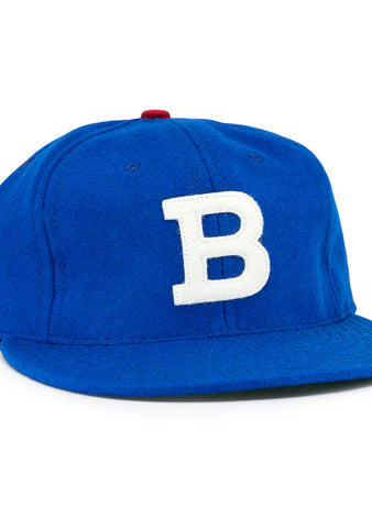 The EFF Los Barbudos 1959 Vintage Ballcap is a genuine wool blue baseball hat with a white B on the front and a small red button on top, shown against a white background.