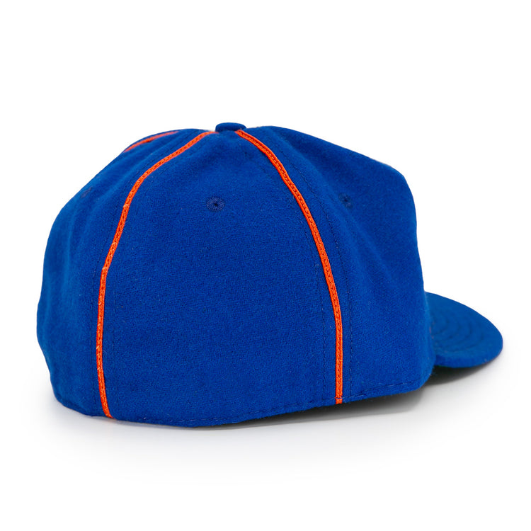 The EFF Boston Bloomer Girls 1910 Vintage Ballcap is a blue baseball cap with a curved brim and two orange stripes down the back, inspired by classic women’s baseball and reminiscent of early 20th-century style.
