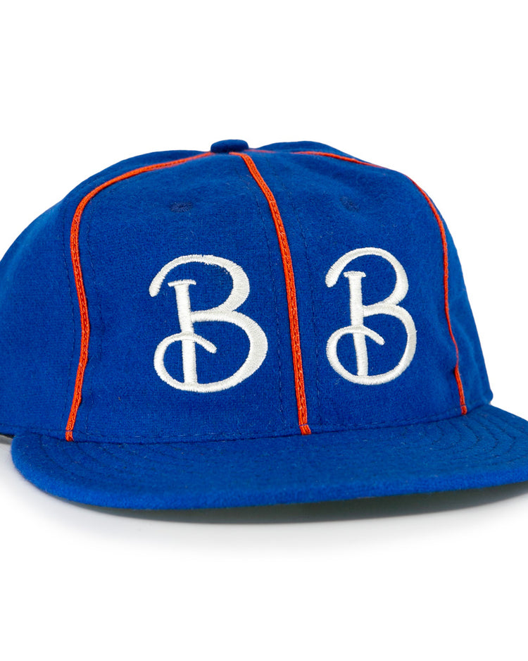 The EFF Boston Bloomer Girls 1910 Vintage Ballcap features royal blue fabric, red piping, and bold white intertwined B embroidery, inspired by the historic womens baseball team.
