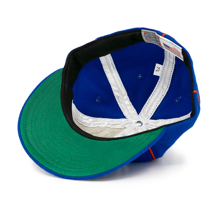 The EFF Boston Bloomer Girls 1910 Vintage Ballcap is shown inside out, highlighting its green underbrim, white stitching, size 7 3/4 tag, and American flag tag—a nod to women’s baseball history. White background.