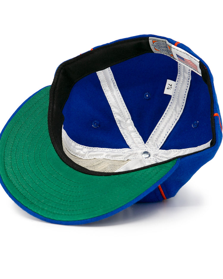 The EFF Boston Bloomer Girls 1910 Vintage Ballcap is shown inside out, highlighting its green underbrim, white stitching, size 7 3/4 tag, and American flag tag—a nod to women’s baseball history. White background.