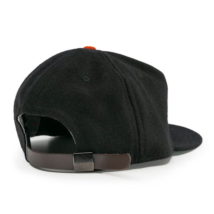 The EFF Bisbee-Douglas Copper Kings 1951 Vintage Ballcap features classic wool style, a brown adjustable strap with metal buckle, and an orange top button—capturing the iconic look of historic ballcaps.