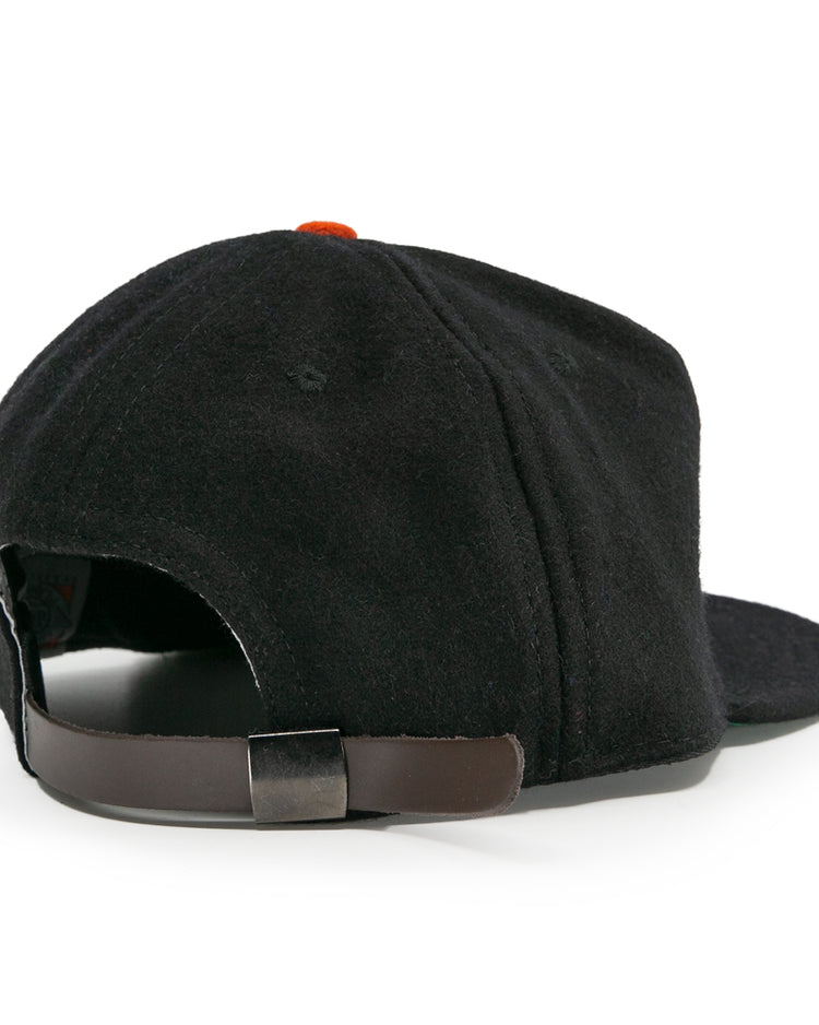 The EFF Bisbee-Douglas Copper Kings 1951 Vintage Ballcap features classic wool style, a brown adjustable strap with metal buckle, and an orange top button—capturing the iconic look of historic ballcaps.