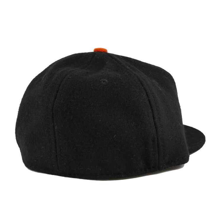 The EFF Bisbee-Douglas Copper Kings 1951 Vintage Ballcap is a classic wool hat, seen from the back with no visible logos or designs, featuring a small orange top button—an understated nod to vintage ballcap styles.