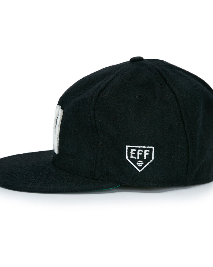 The EFF Brooklyn Eagles Vintage Inspired Ballcap is a black baseball hat with a small white embroidered EFF shield logo on the side, channeling classic Brooklyn Eagles style.