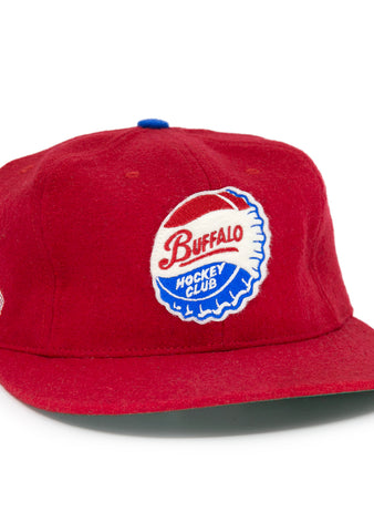 The EFF Buffalo Bisons 1963 Vintage Ballcap is a red wool cap with a round Buffalo Hockey Club patch on the front and small embroidered US and Canadian flags—a classic tribute to the Bisons and American Hockey League.