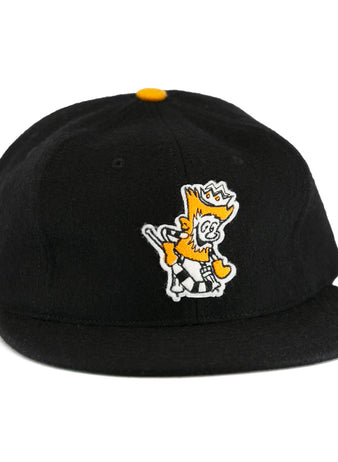 The EFF Brandon Wheat Kings 1955 Vintage Ballcap is a black wool hat inspired by classic hockey styles, featuring a yellow and white crowned cartoon lion embroidered on the front and a small yellow shield emblem.