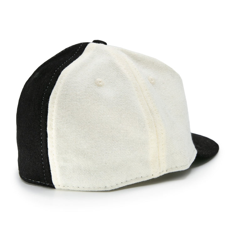 The EFF Bacharach Giants 1924 Vintage Ballcap, crafted from genuine wool, features black and white panels, visible stitching, ventilation holes, and is shown from the back-left side.