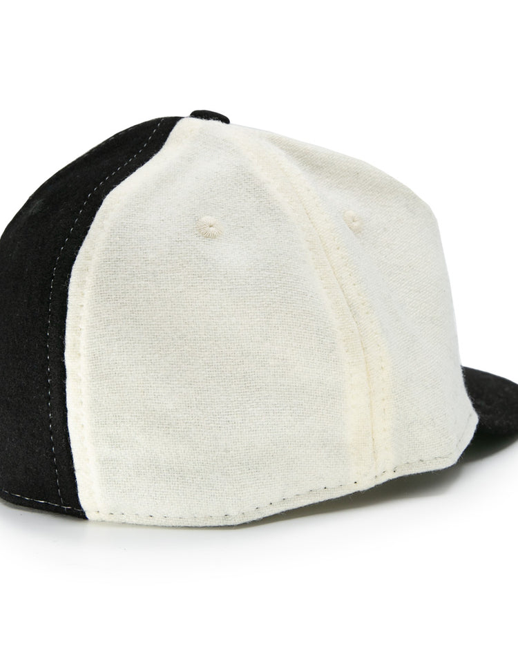 The EFF Bacharach Giants 1924 Vintage Ballcap, crafted from genuine wool, features black and white panels, visible stitching, ventilation holes, and is shown from the back-left side.
