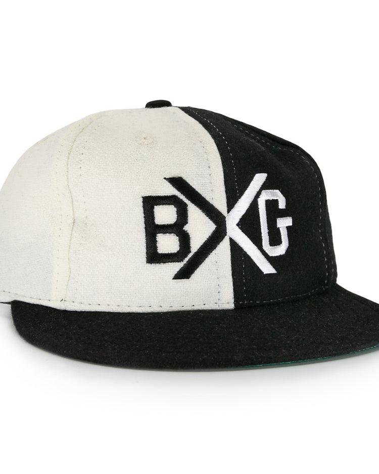 The EFF Bacharach Giants 1924 Vintage Ballcap is crafted from genuine wool and features black and white color blocks, a flat brim, and bold BXG embroidery on the front, inspired by the classic 1924 design.