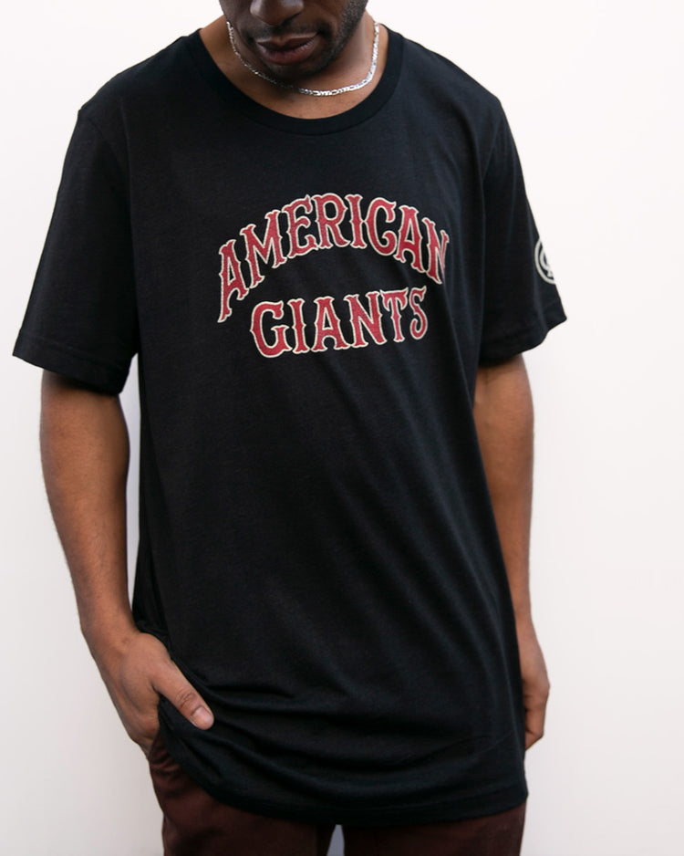 A person wears the EFF Chicago American Giants T-Shirt, featuring “CHICAGO AMERICAN GIANTS” in red and white letters, honoring Black baseball heritage, while standing against a plain white background.