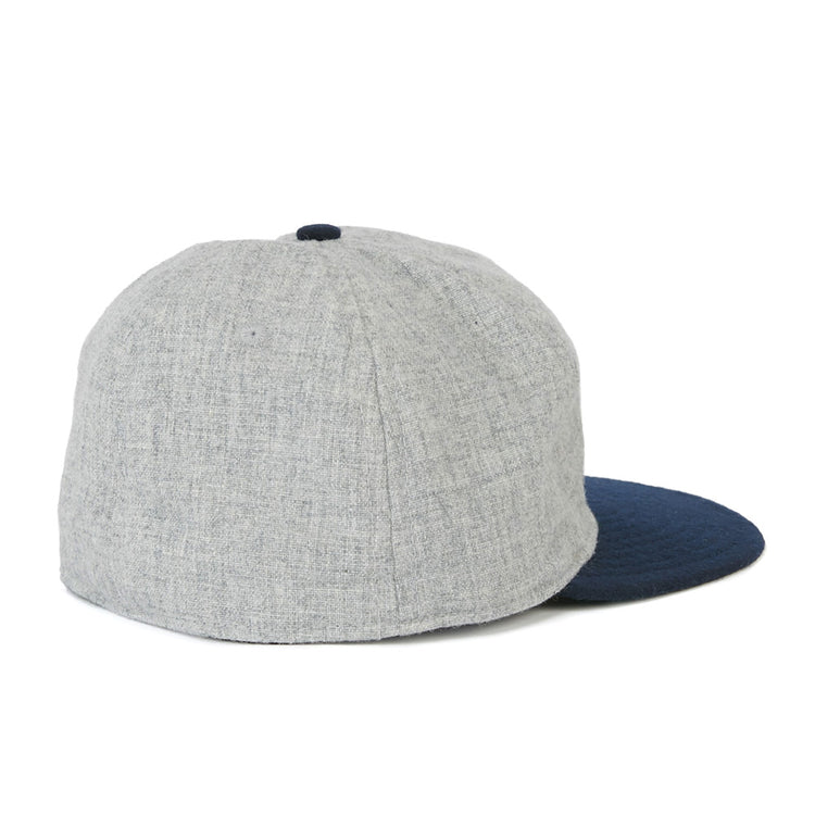 The EFF Cerveceria Caracas 1942 Vintage Ballcap features a light gray crown and dark blue brim, shown from the back at a slight angle on a white background, capturing the classic style of the Venezuelan League team.