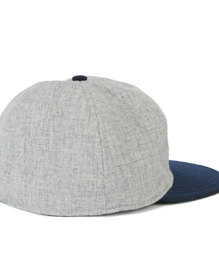 The EFF Cerveceria Caracas 1942 Vintage Ballcap features a light gray crown and dark blue brim, shown from the back at a slight angle on a white background, capturing the classic style of the Venezuelan League team.