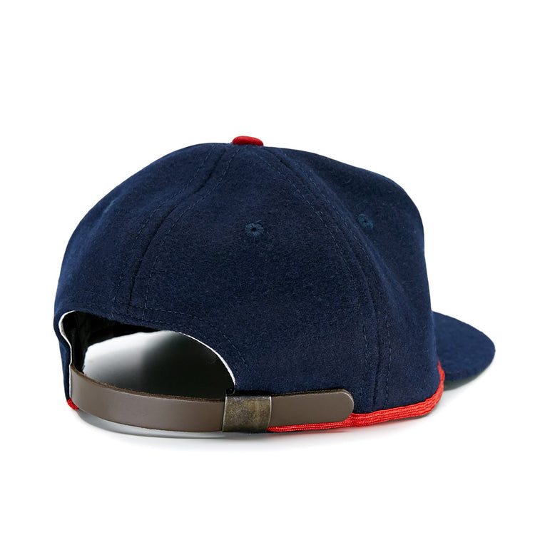 The EFF Cleveland Buckeyes 1947 Vintage Ballcap is a navy wool cap shown from the back, featuring a brown adjustable strap and red trim along the bottom edge.