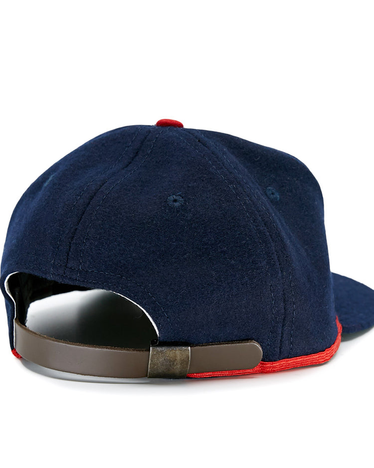 The EFF Cleveland Buckeyes 1947 Vintage Ballcap is a navy wool cap shown from the back, featuring a brown adjustable strap and red trim along the bottom edge.