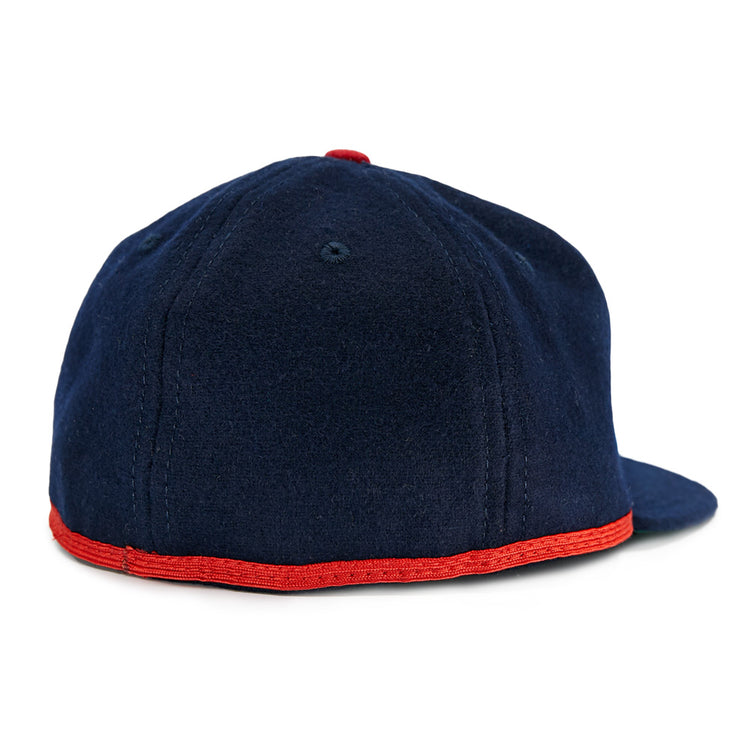The EFF Cleveland Buckeyes 1947 Vintage Ballcap is a dark blue wool cap with visible stitching, flat brim, red trim along the edge, and a small red top button—shown from the back.
