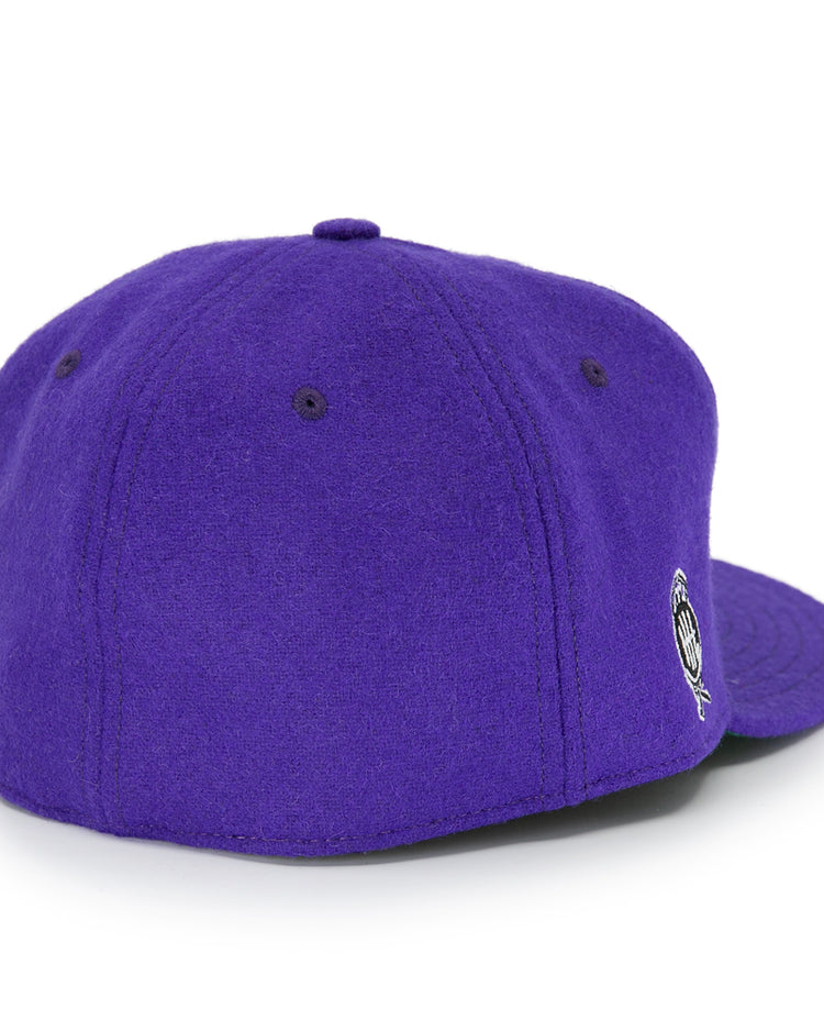 The EFF Cleveland Falcons 1936 Vintage Ballcap is a purple wool cap shown from the back, with stitched panels, a top button, an adjustable leather strap, and a small round embroidered logo on the side.