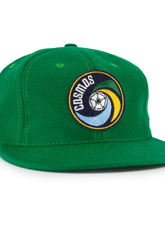 The EFF New York Cosmos 1976 Vintage Ballcap is a wool cap with a flat brim, featuring the teams classic soccer ball and swirl logo on the front—a tribute to the iconic NASL era.