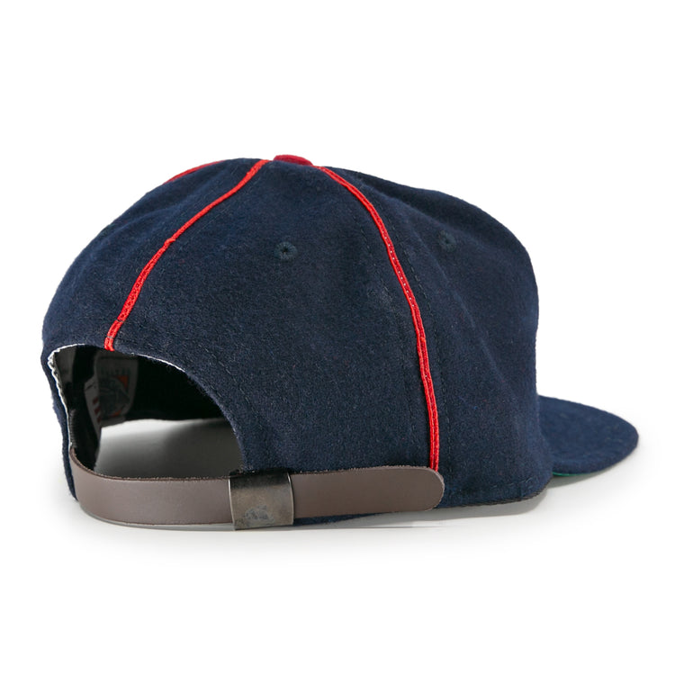 The EFF Danville Veterans 1932 Vintage Ballcap is a navy blue baseball cap with red panel stitching, seen from the back with an adjustable brown leather strap and metal buckle.